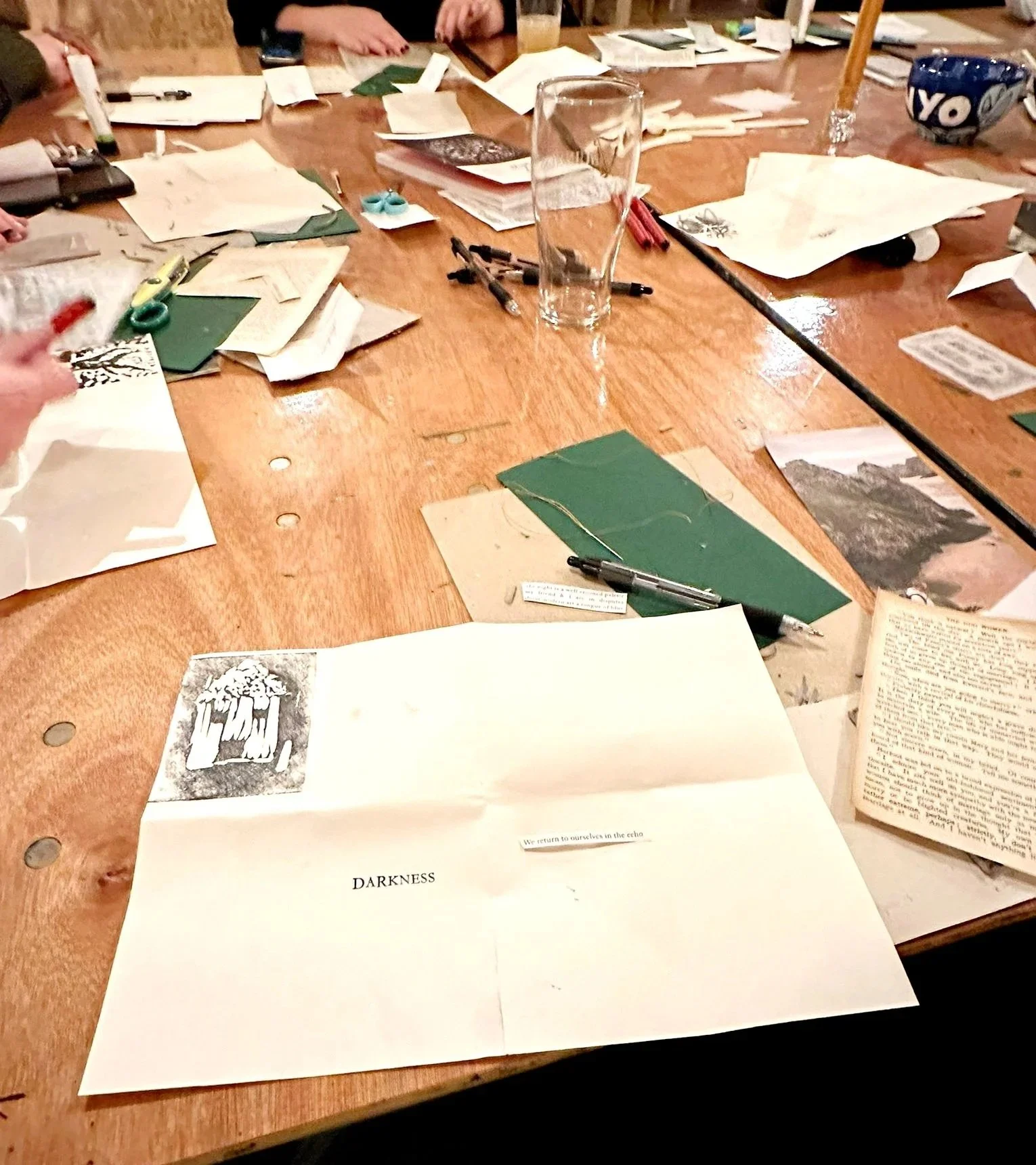 A messy table of hand made books in progress