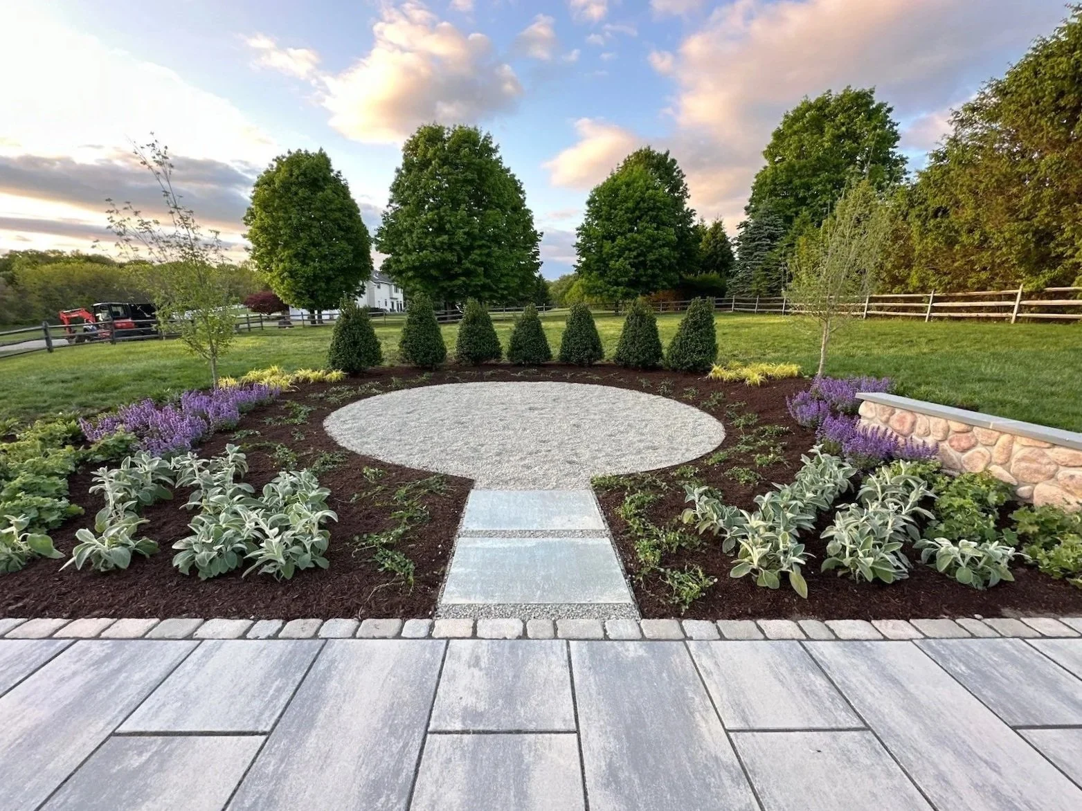 Beautiful stone area with plantings, mulch, and stone retaining wall