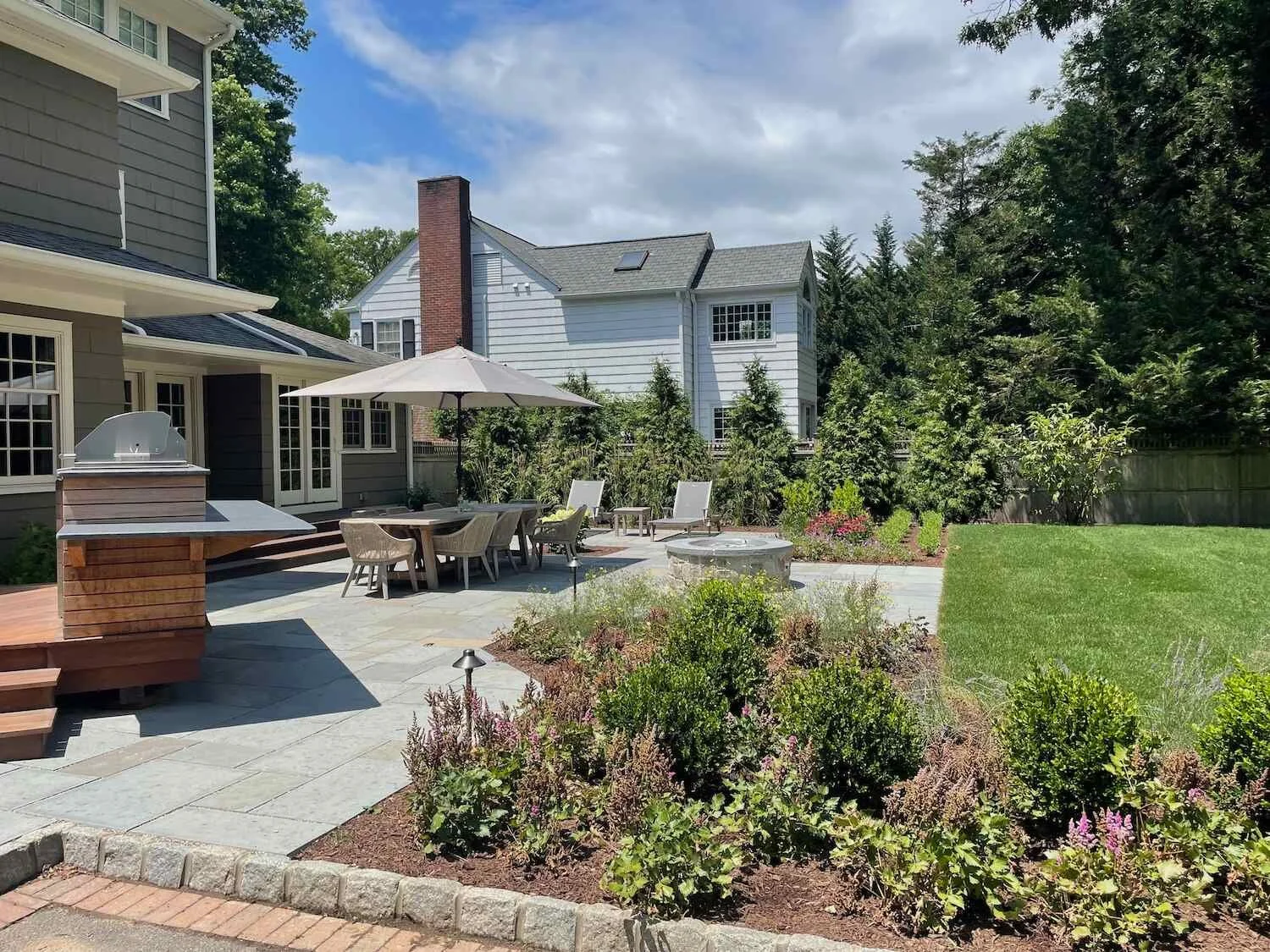 Flagstone path bordered by seasonal plantings and brick retaining walls in Flanders, NJ.jpeg