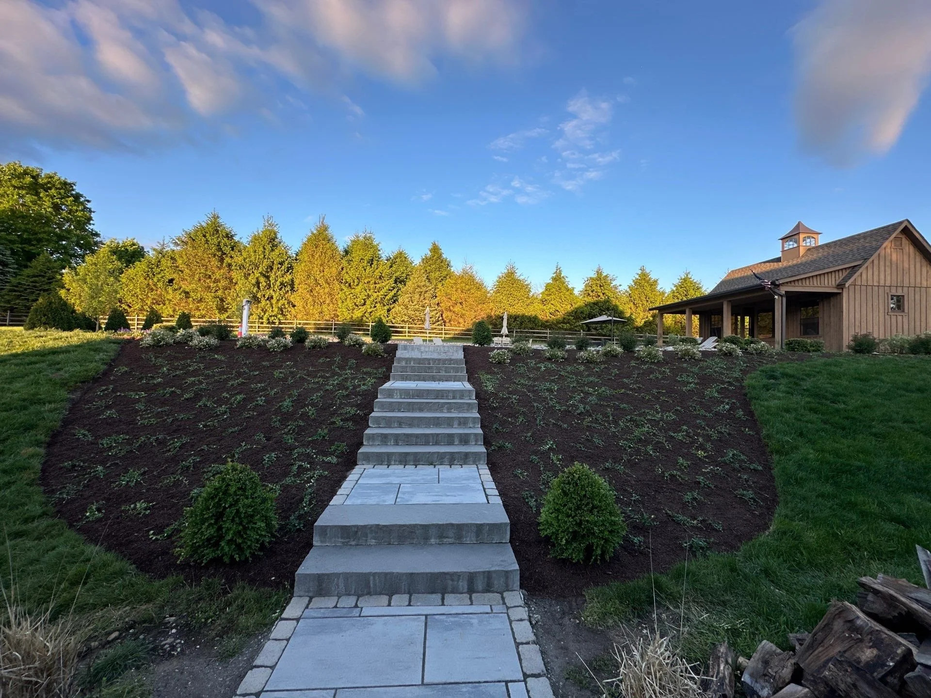 Stone steps and mulch garden beds in backyard of Long Valley, NJ home