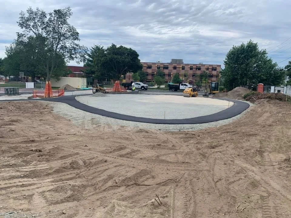 JAM Corporation vehicles are on site where they have levelled and prepped the site where a new playground will be installed in Arlington, MA