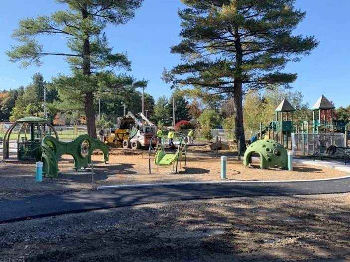 A view of the full playground at Fitchburg's Sam Pawlak Park after it has been newly installed.  The playground includes multiple new playscapes and playground equipment. 