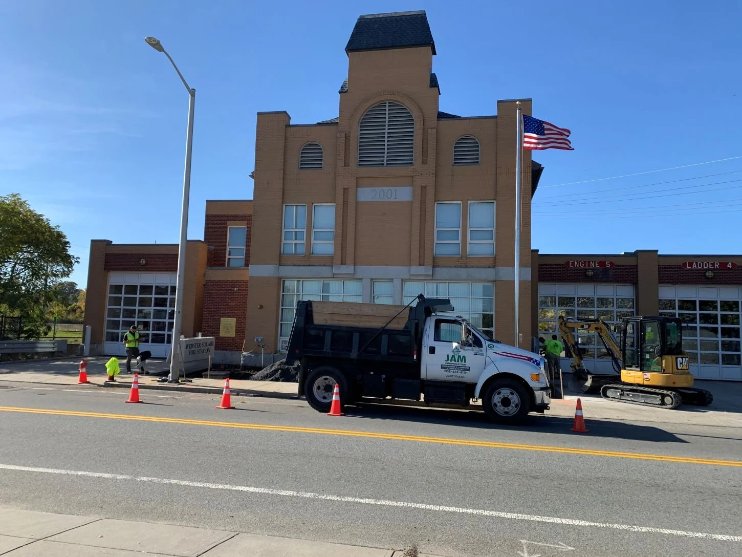 JAM Corporation's dump truck is parked in front of Worcester's firehouse where a new Memorial is being installed.