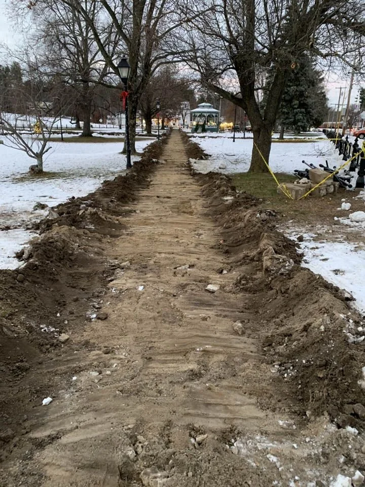 A view looking straight down the newly dug and levelled path for the new walkway in Townsend Common, with snow on the ground on either side of the path.