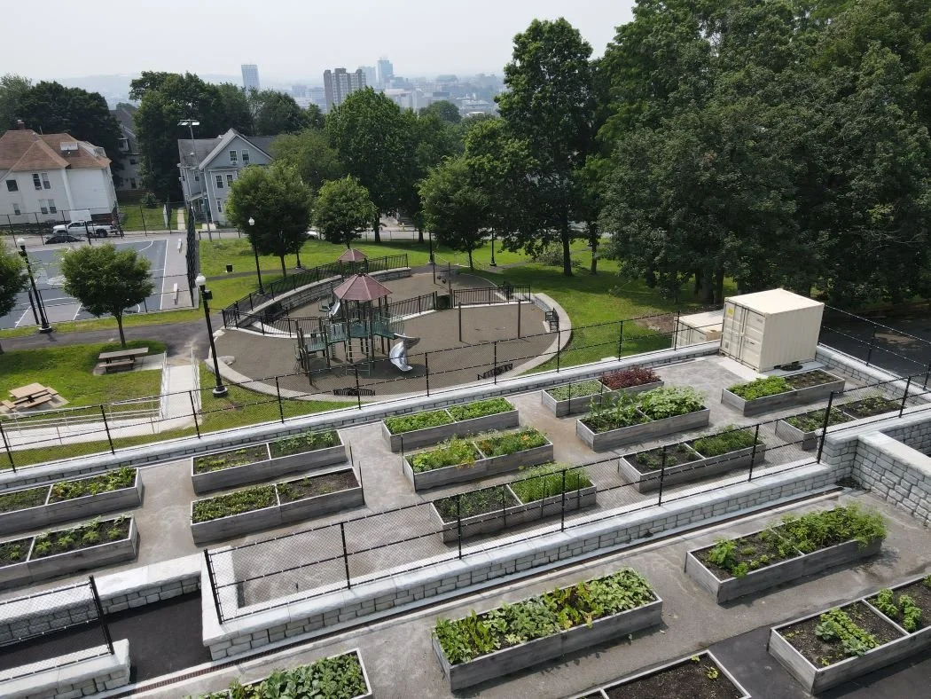 An Aerial View of the Worcester Grant Square Community Gardens that have planter boxes and a playground newly installed.