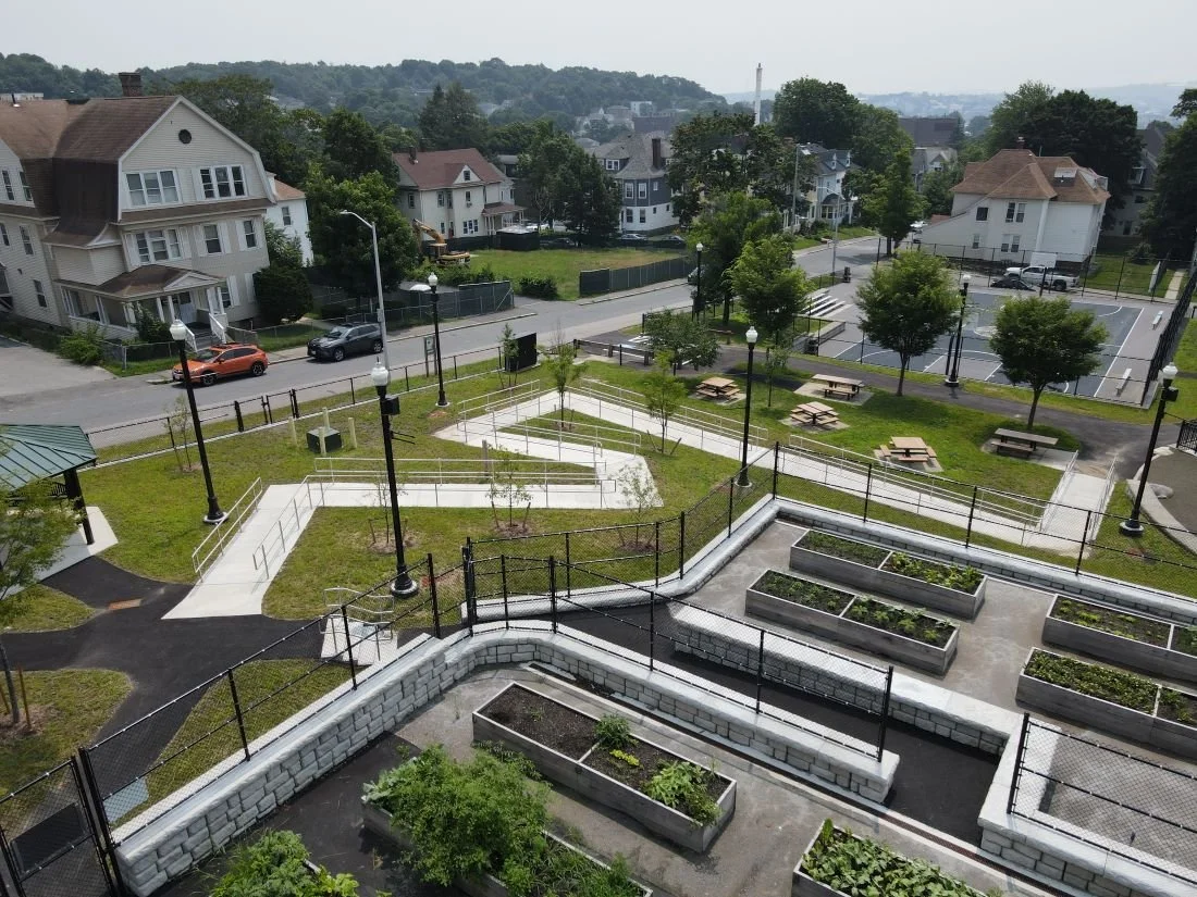 Aerial view of the left side of the Grant Square Community Garden with a new walkway installed zig zagging down to the playground.