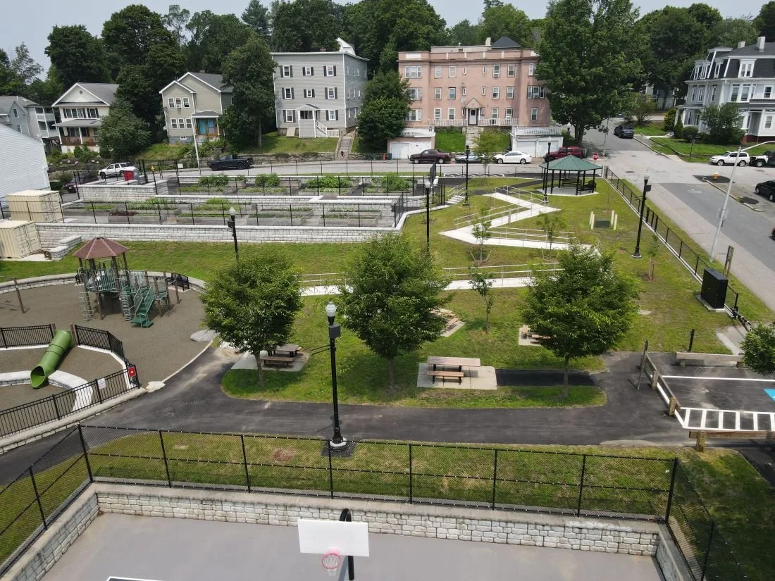 An Aerial view of the ball court, playground, and raised planters.