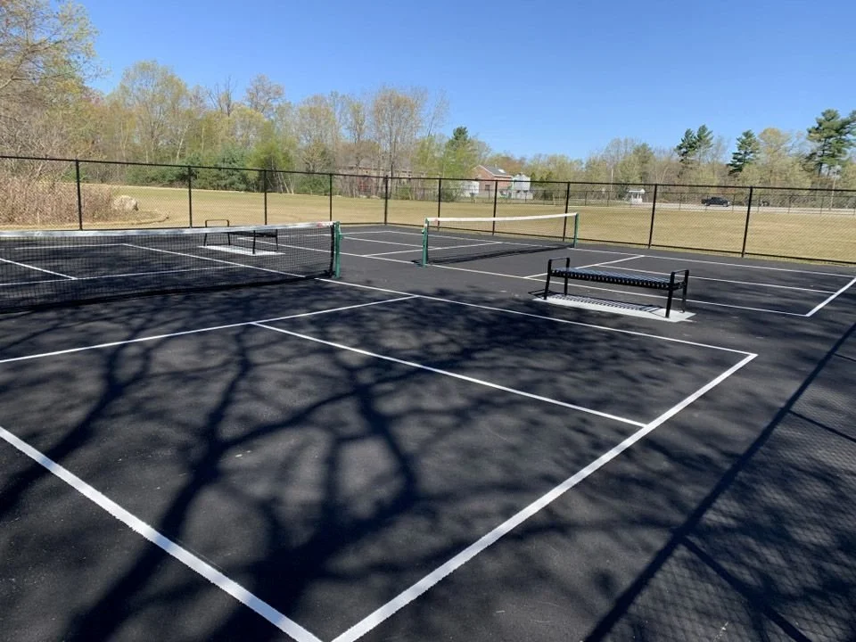The completed tennis courts at Webster Memorial Beach Playground on a beautifully sunny, cloudless day.