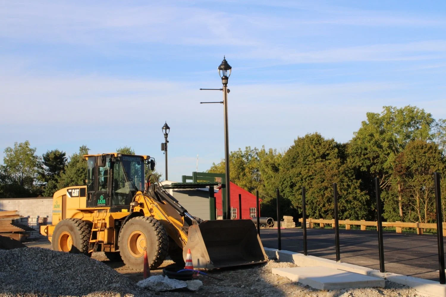 A loader is parked in site next to a pile of gravel where a new park is being constructed in Worcester, MA.