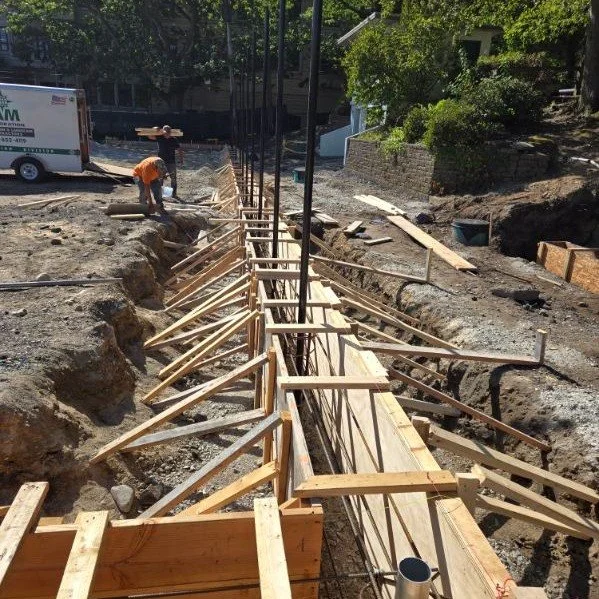 Progress is being made in Brookline, Amory Park- Curb wall for new tennis court has been installed along with footings for staircase.