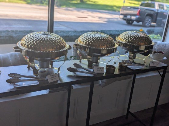 Chafing dishes with custom-named appetizers at a Main Line corporate happy hour