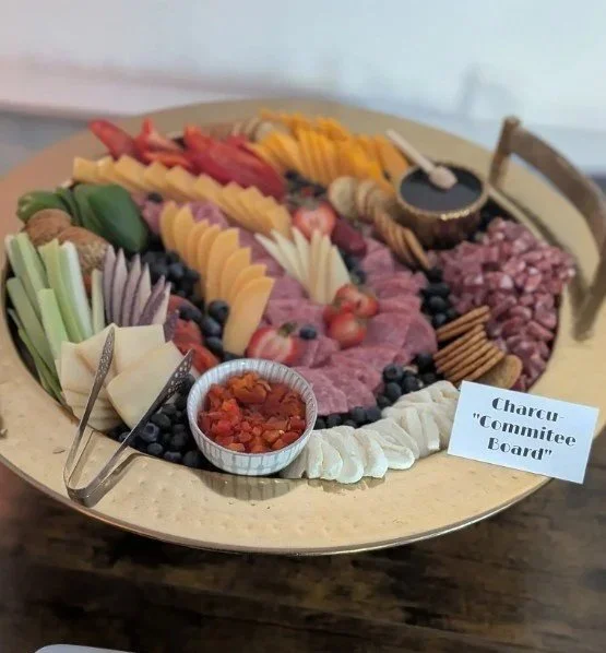 Charcuterie board with custom SBA-themed signage at a Main Line networking event