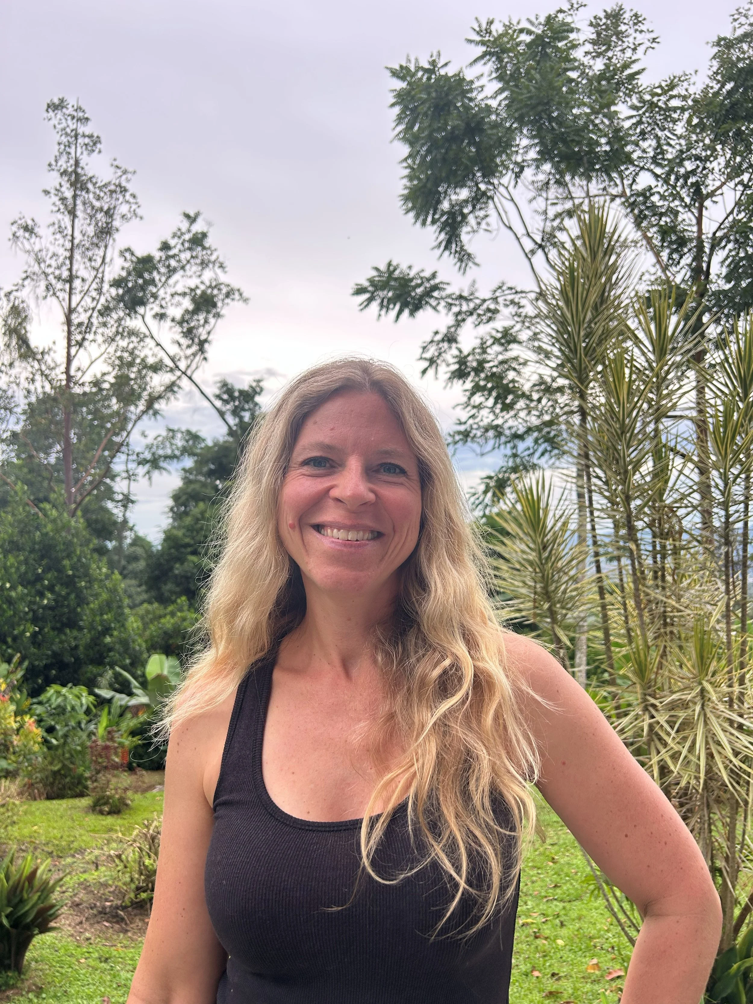 Health coach Nina Kubin smiling in her garden