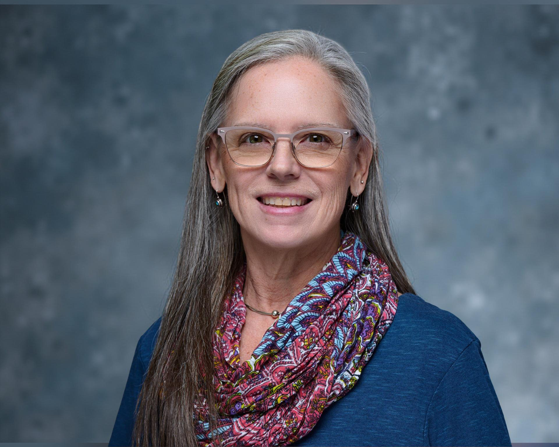Person wearing glasses and a colorful scarf