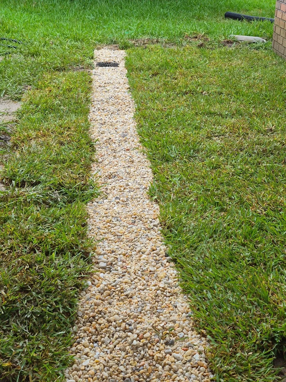 French drain installation in Pensacola, Florida designed to improve yard drainage, reduce standing water, and protect the property's foundation.