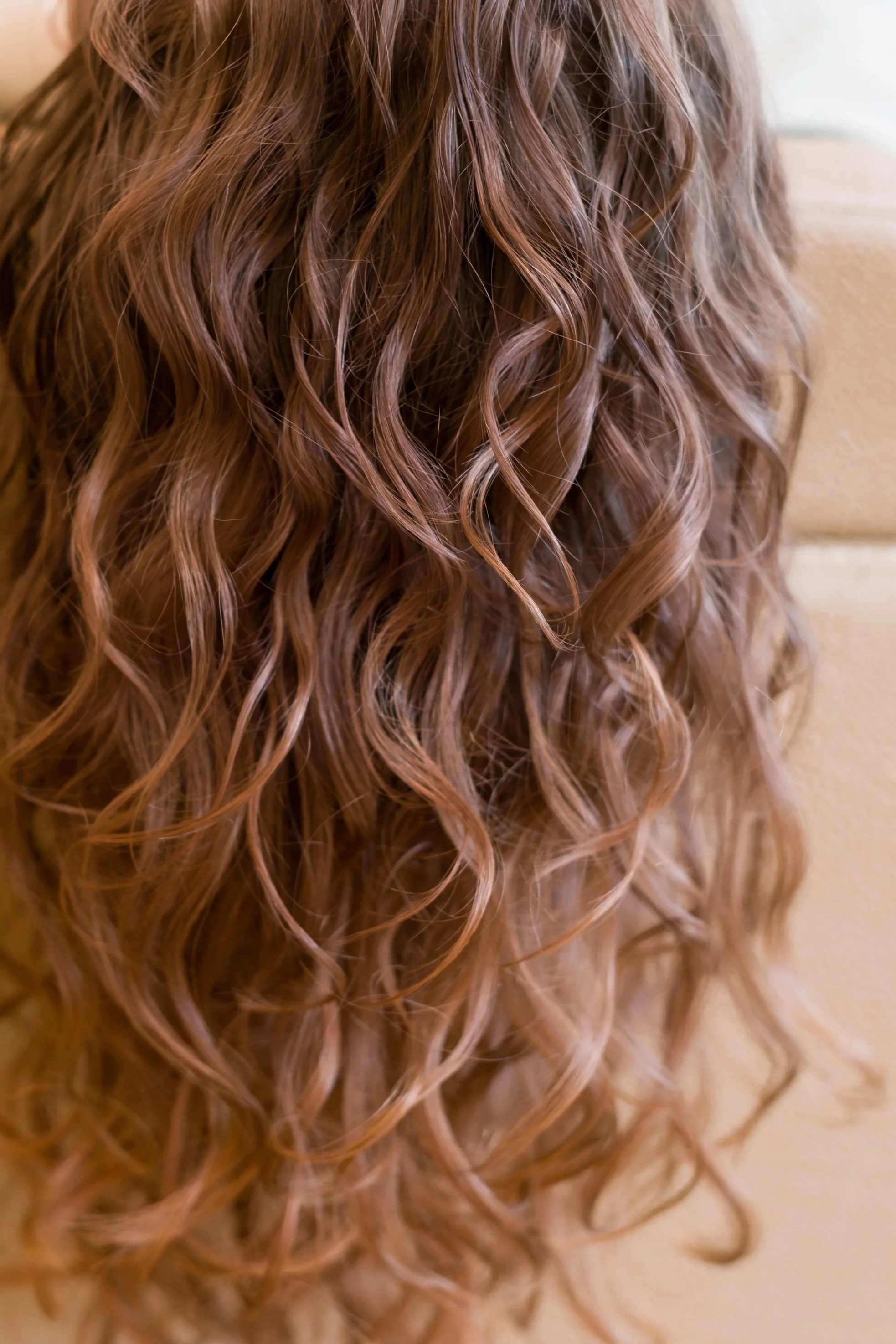 Close-up of defined, wavy hair styled using curl specialist techniques by Yasmine Byfield Hair, Curly Hair Educator and Specialist, Walsall, West Midlands UK.