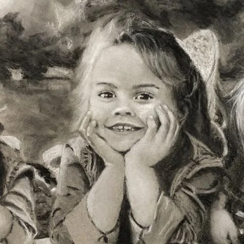 A young girl with curly hair, smiling with her hands on her cheeks.