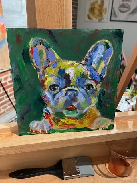 A colorful abstract painting of a French Bulldog puppy with prominent ears and expressive eyes, on a green background.