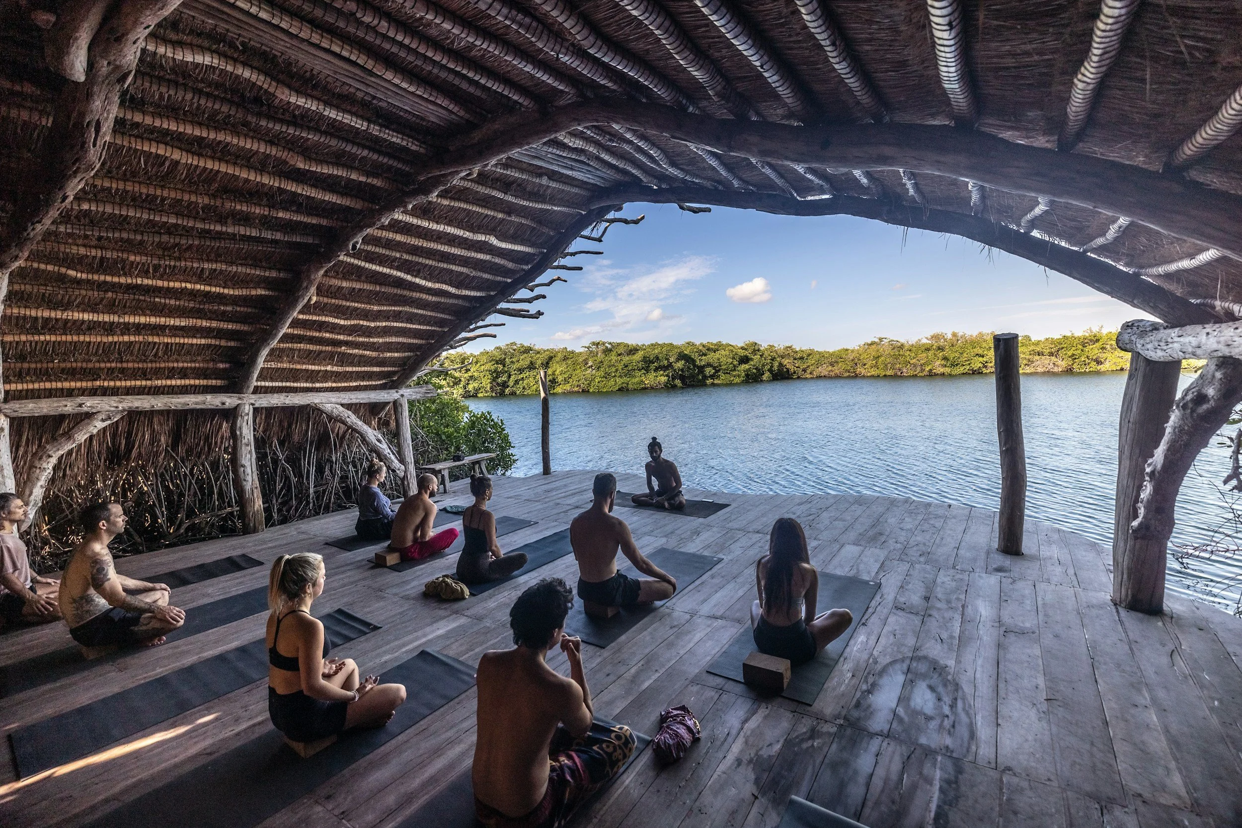 Woman on a wellbeing retreat relaxing in nature, taking time to rest and recharge.