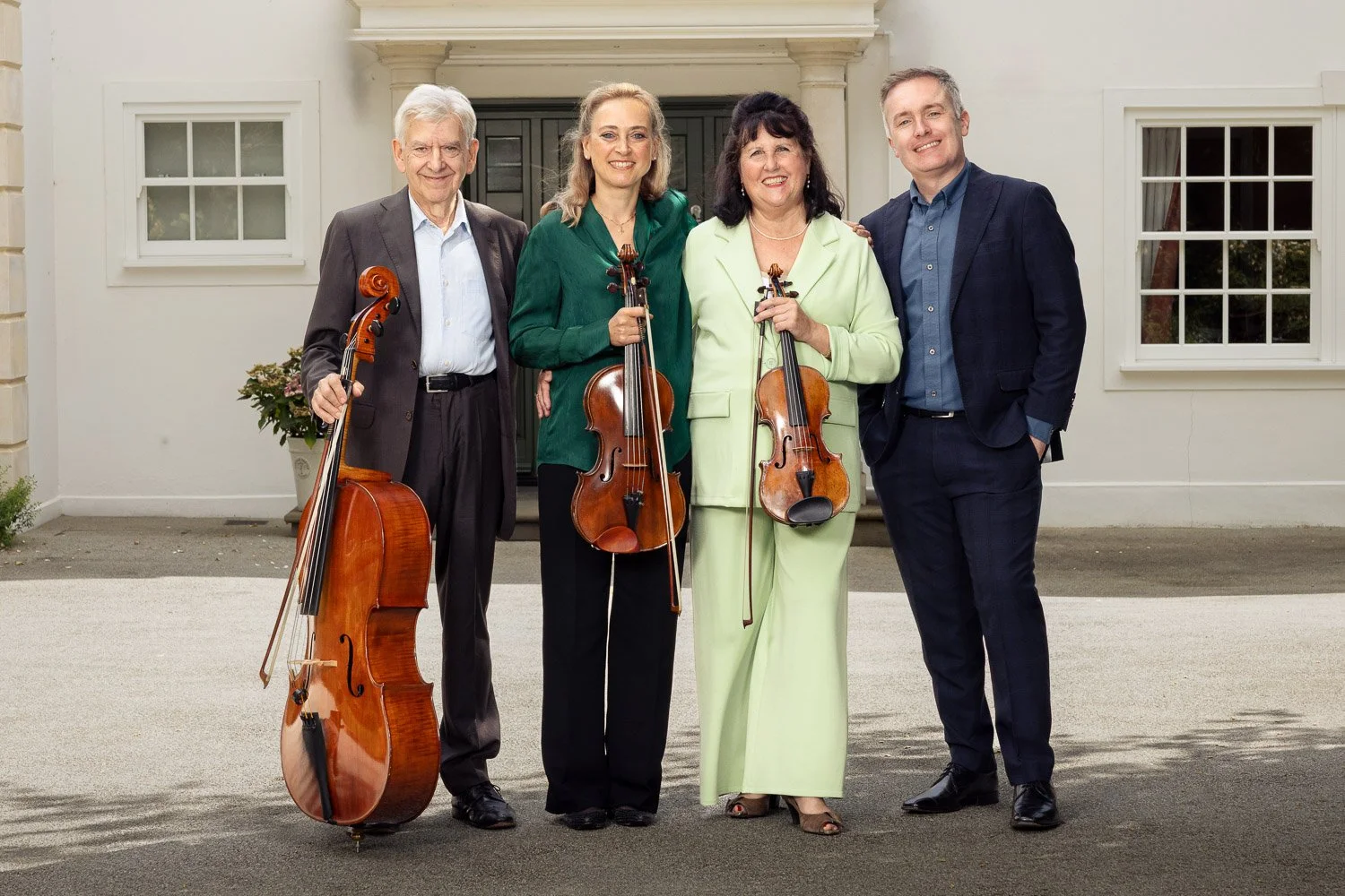 The Zoffany Ensemble piano quartet with violin, viola and cello standing outside their rehearsal venue in Arkley, Barnet