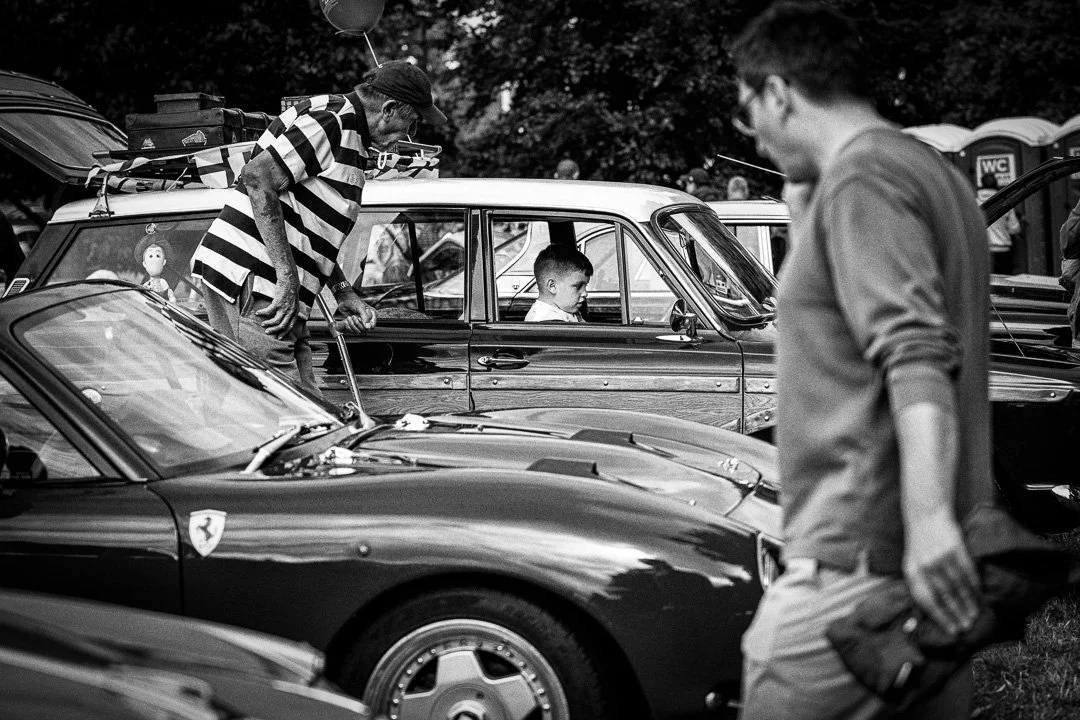 A young boy sits in the drivers seat at the Redbourn Classic Motor Show.jpg