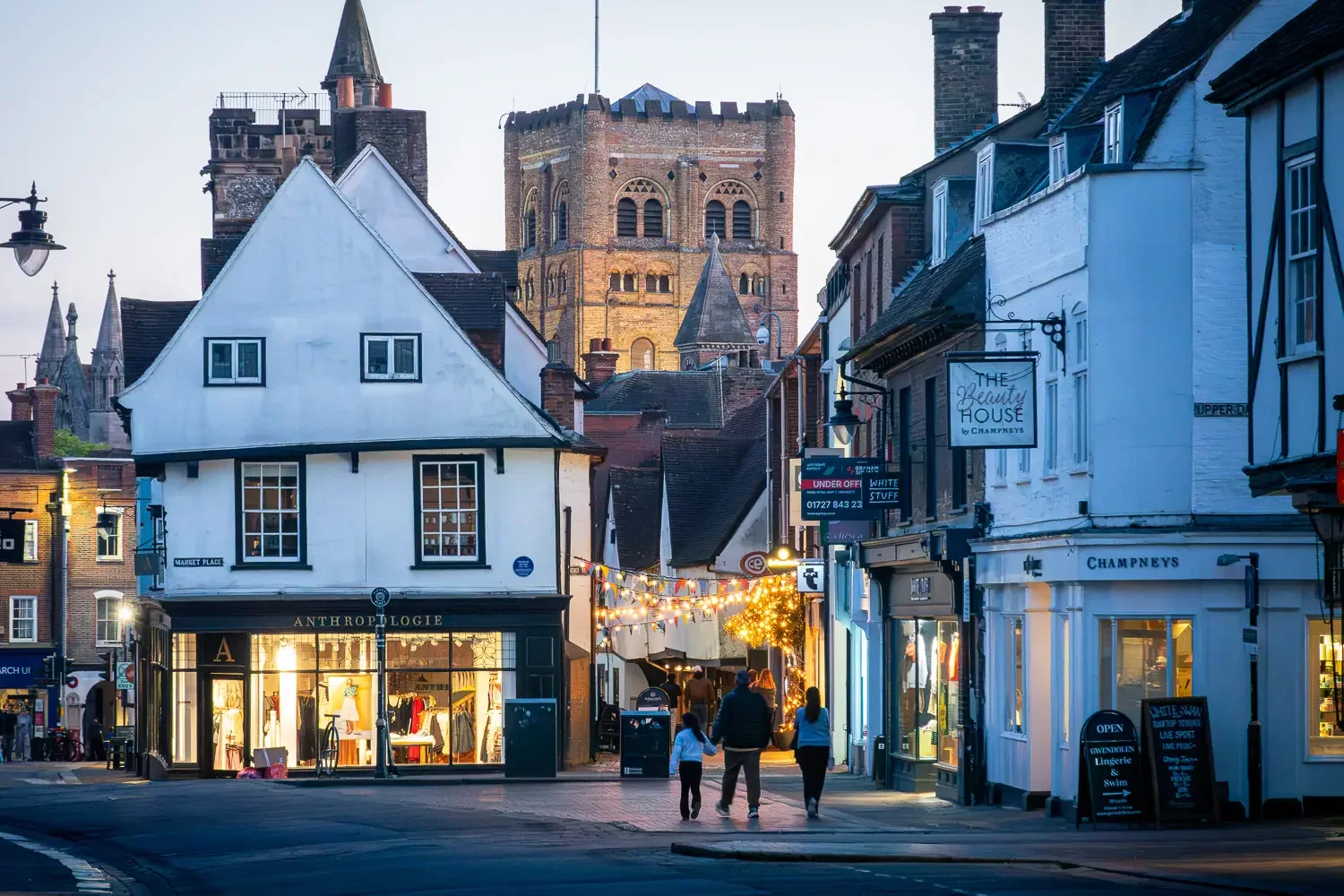 The cathedral tower framed by the historic shopfronts of Market Place