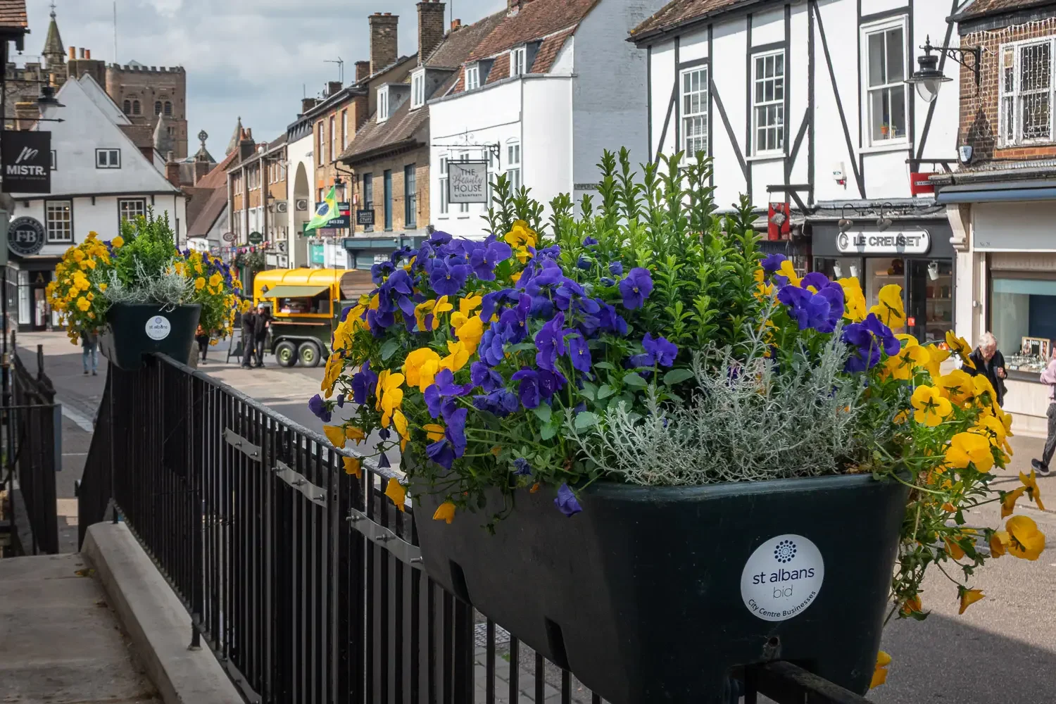 St Albans BID flower planters on railings along the high street