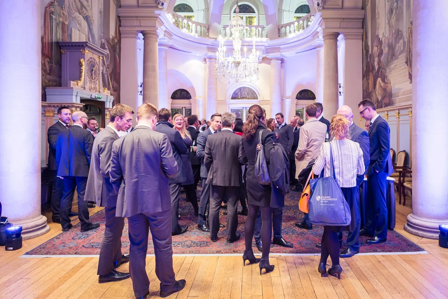 Corporate drinks reception under a chandelier in a historic London venue