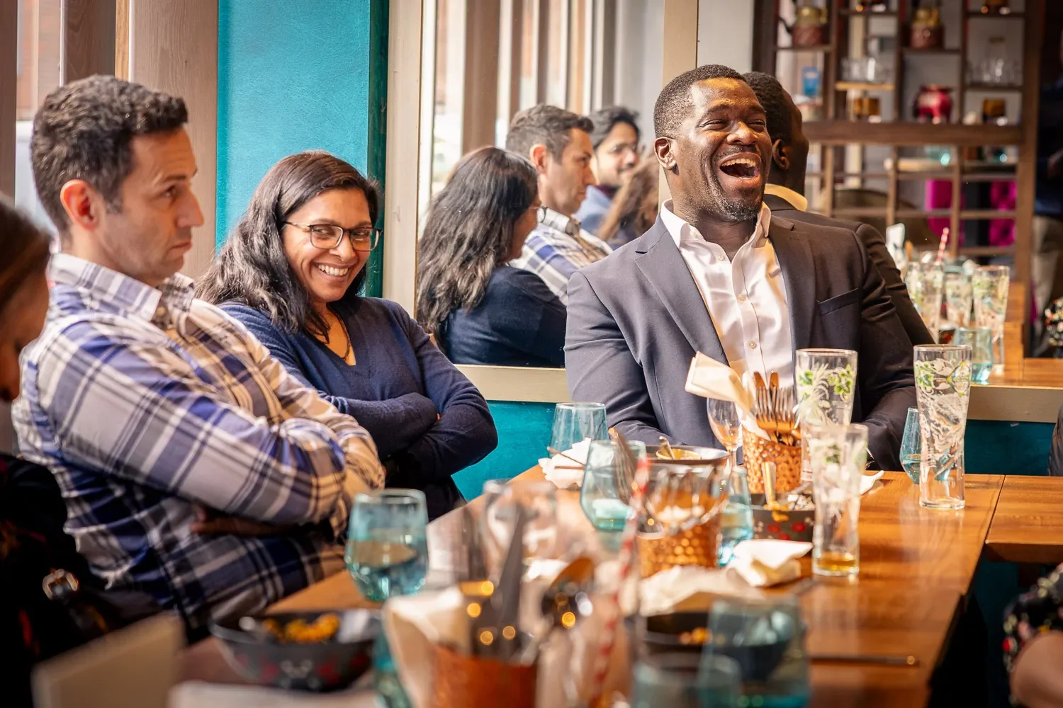 Business professionals laughing at the Small Business Hub curry club lunch at Infuse restaurant, St Albans