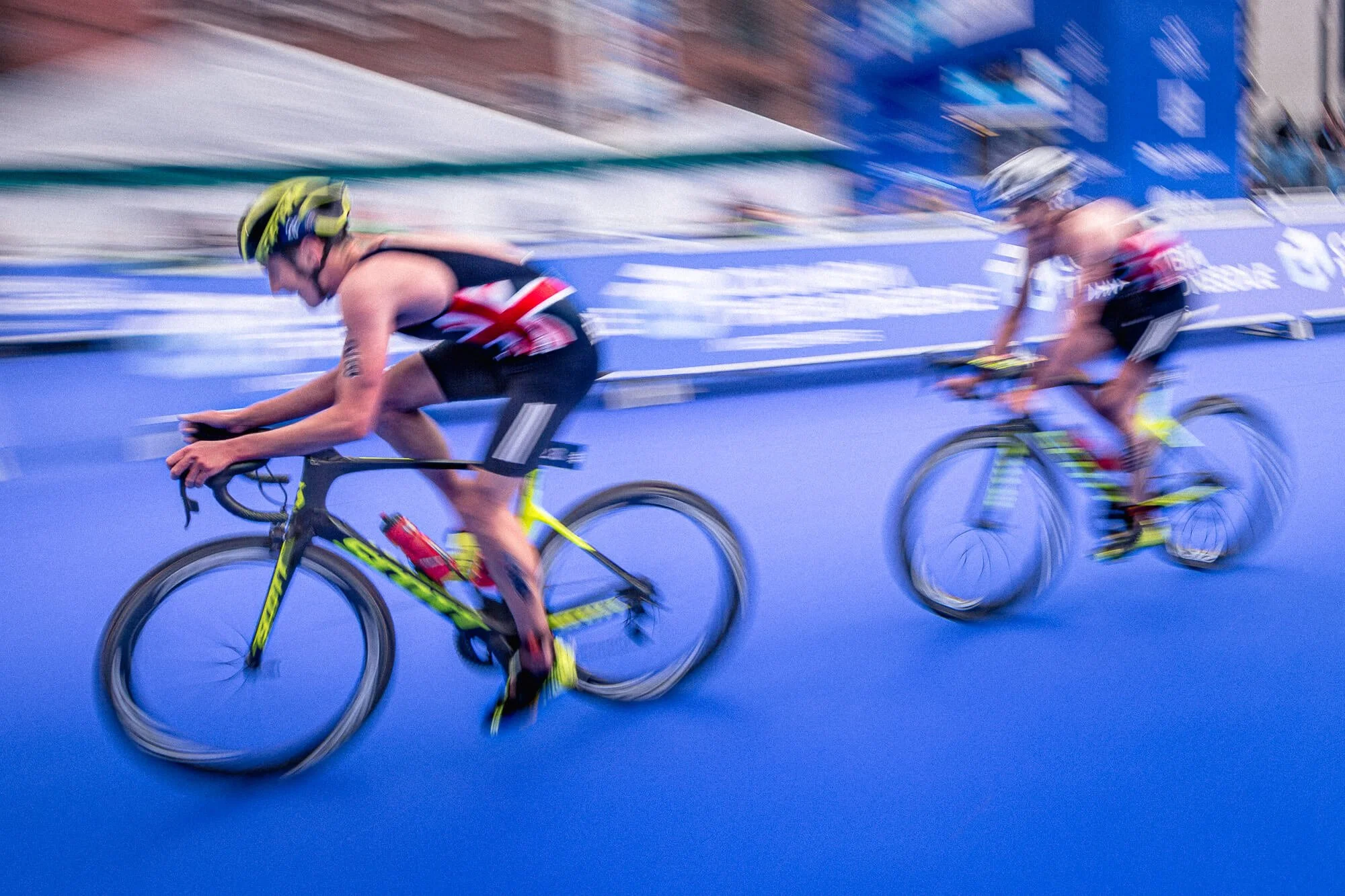 The Brownlee Brothers cycling at speed captured with motion blur on the bike leg