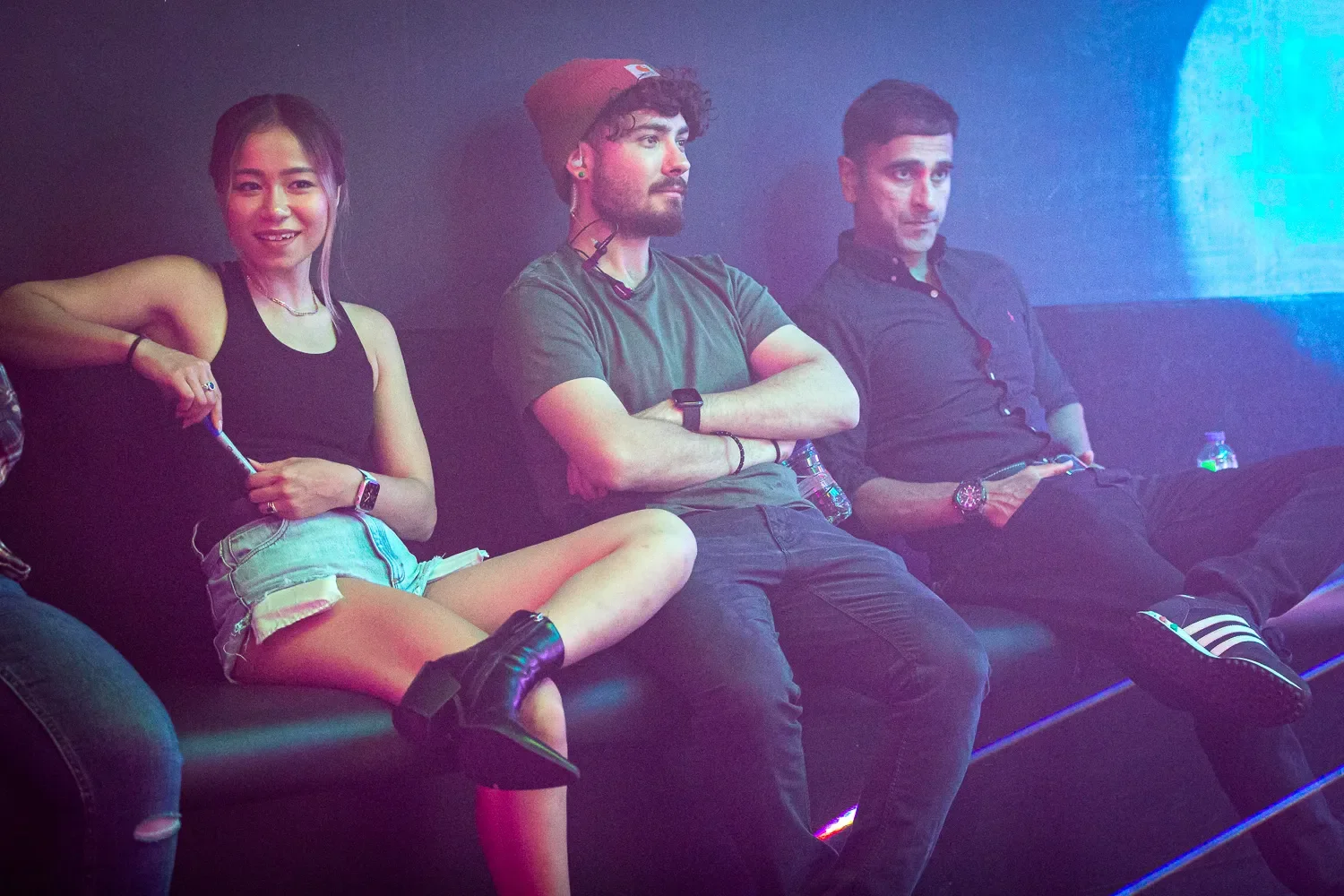 Cast watching playback between takes on music video set, behind-the-scenes documentary photography