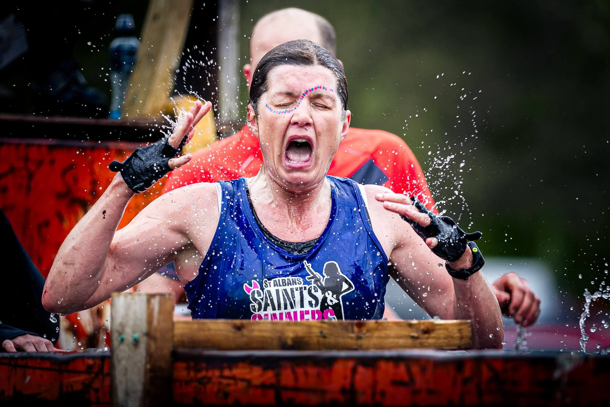 Competitor reacting to cold water plunge during a Hertfordshire obstacle race