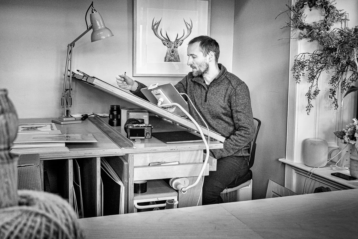 Stuart Scott working at his drawing board at Sasco Art studio, Helensburgh — environmental portrait