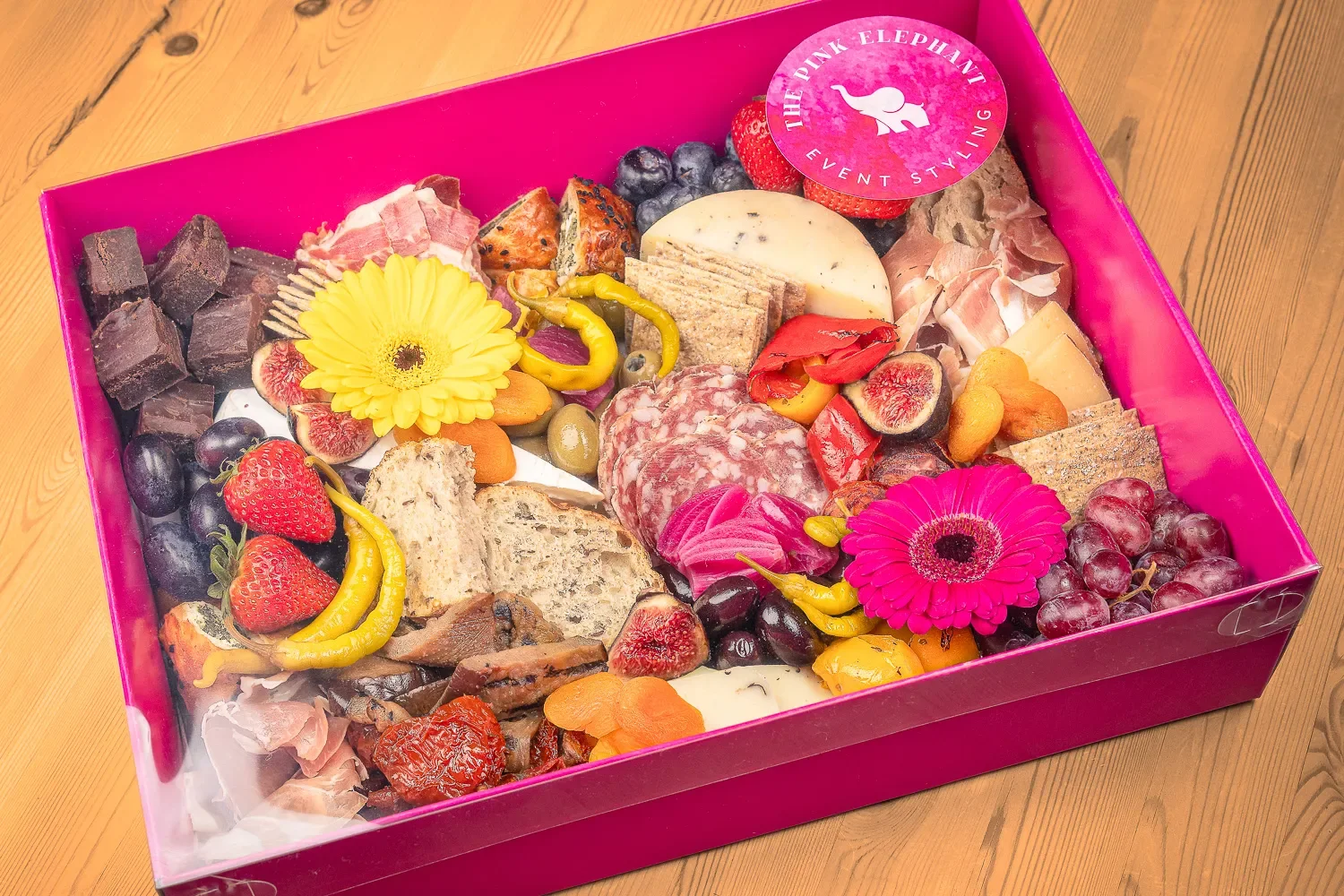 Overhead product photography of Pink Elephant charcuterie box with meats and seasonal fruit, St Albans