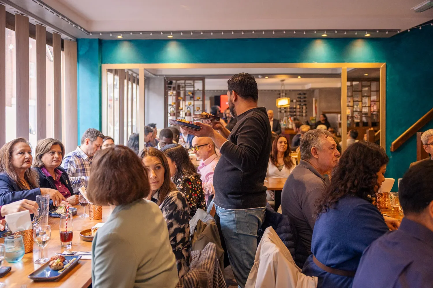 Full room shot of the Small Business Hub curry club lunch at Infuse restaurant, St Albans — over thirty business professionals seated for lunch