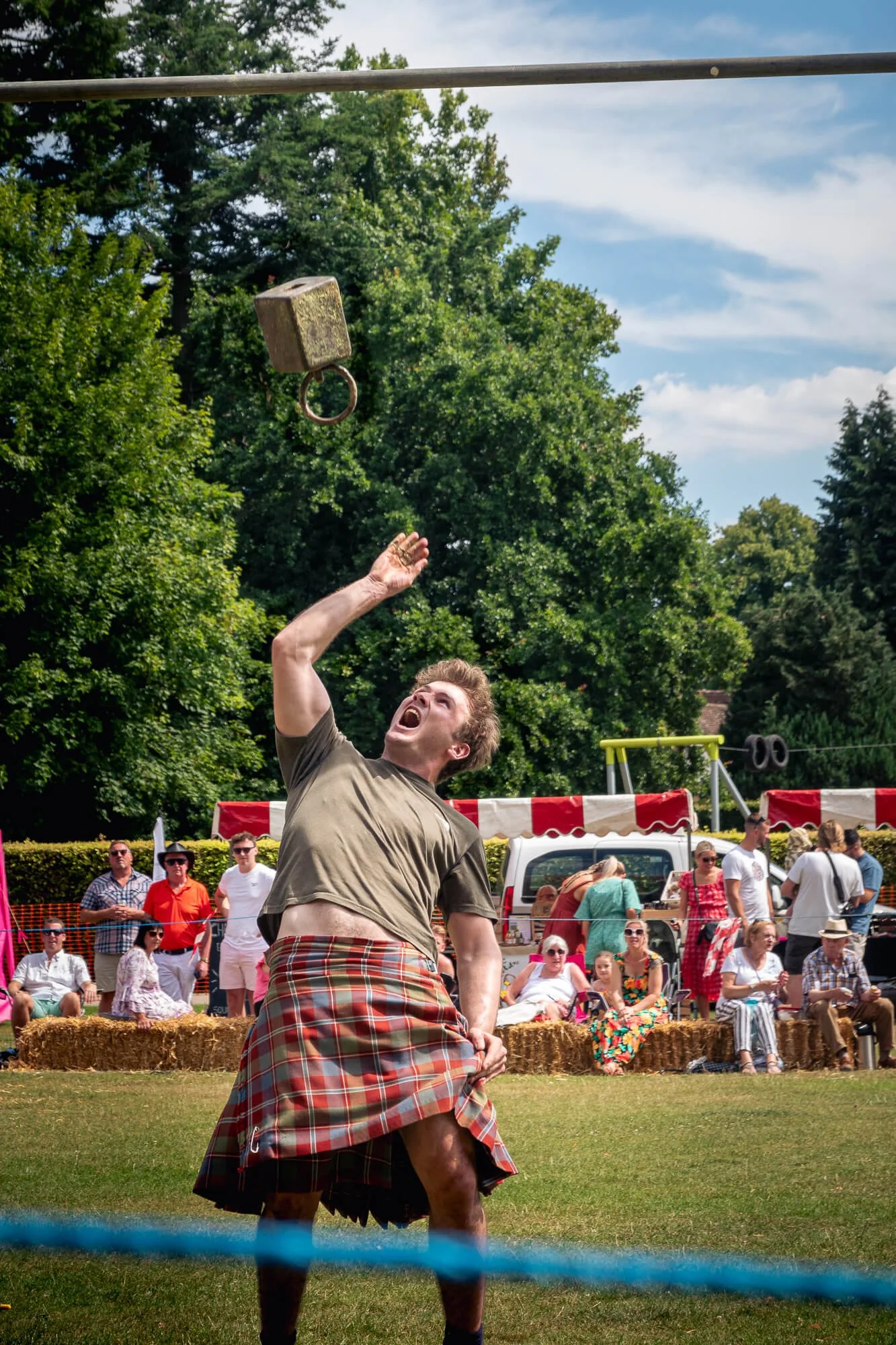 Competitor throwing the weight over the bar at Harpenden Highland Gathering