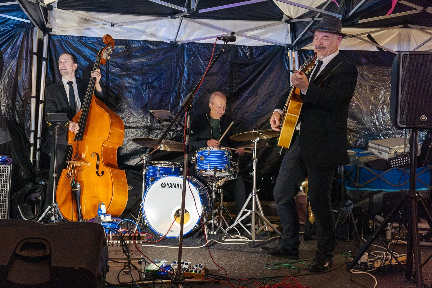 Jazz band playing double bass, drums and guitar live on George Street, St Albans