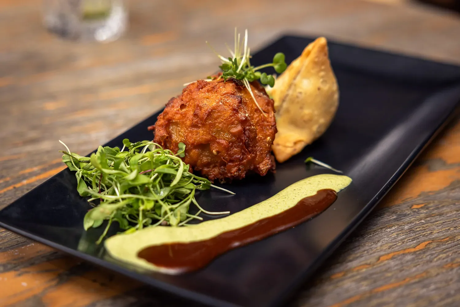 Indian starter plate at Infuse restaurant St Albans — onion bhaji and samosa with chutneys
