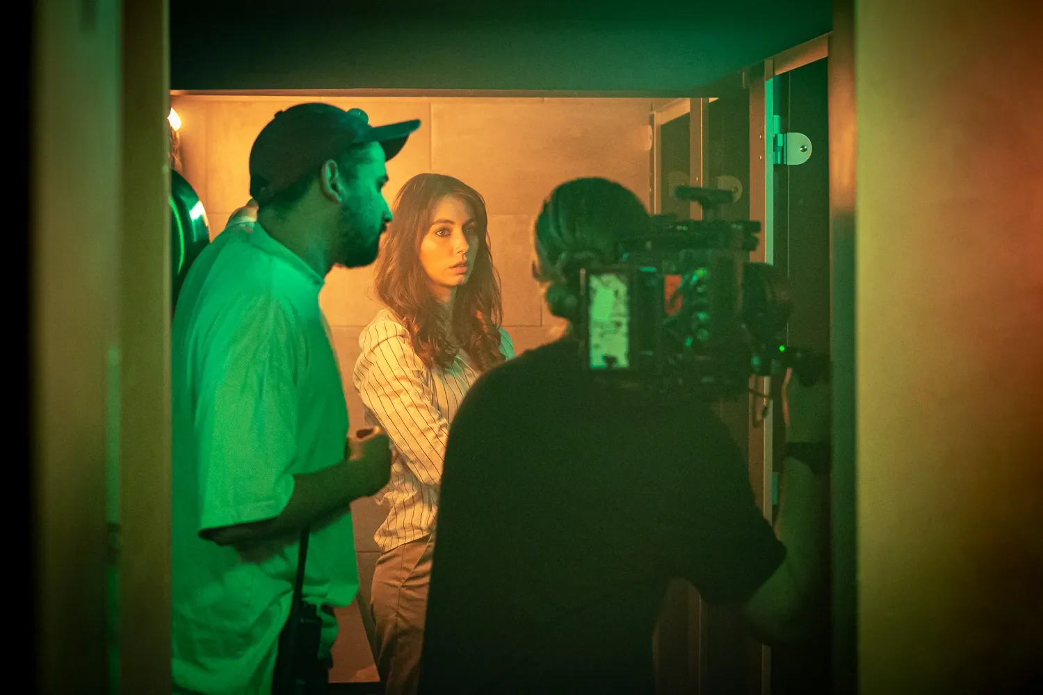 Music video director and actress in doorway between takes, documentary set photography Brighton