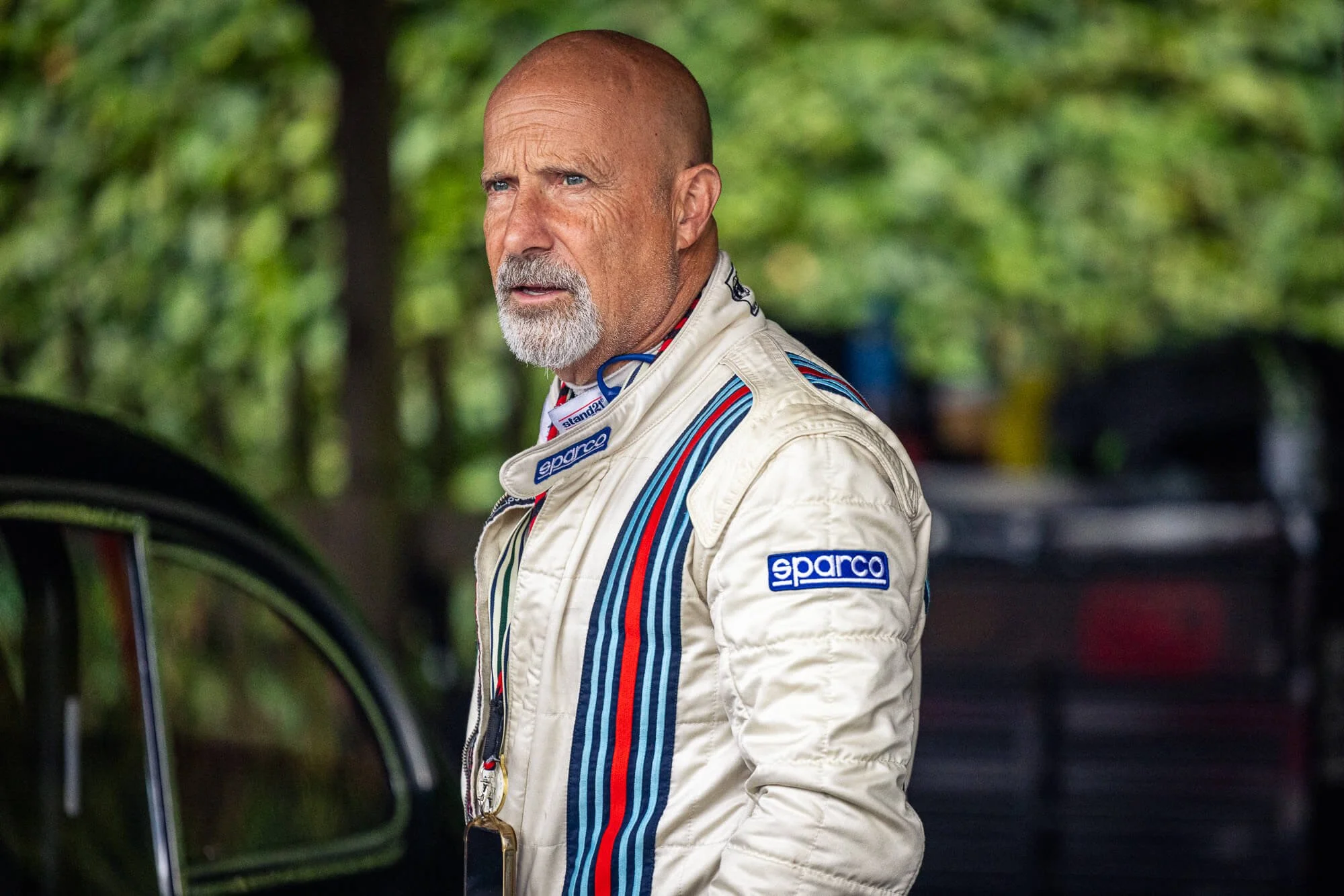 Vintage motorsport driver in racing overalls at Goodwood Revival