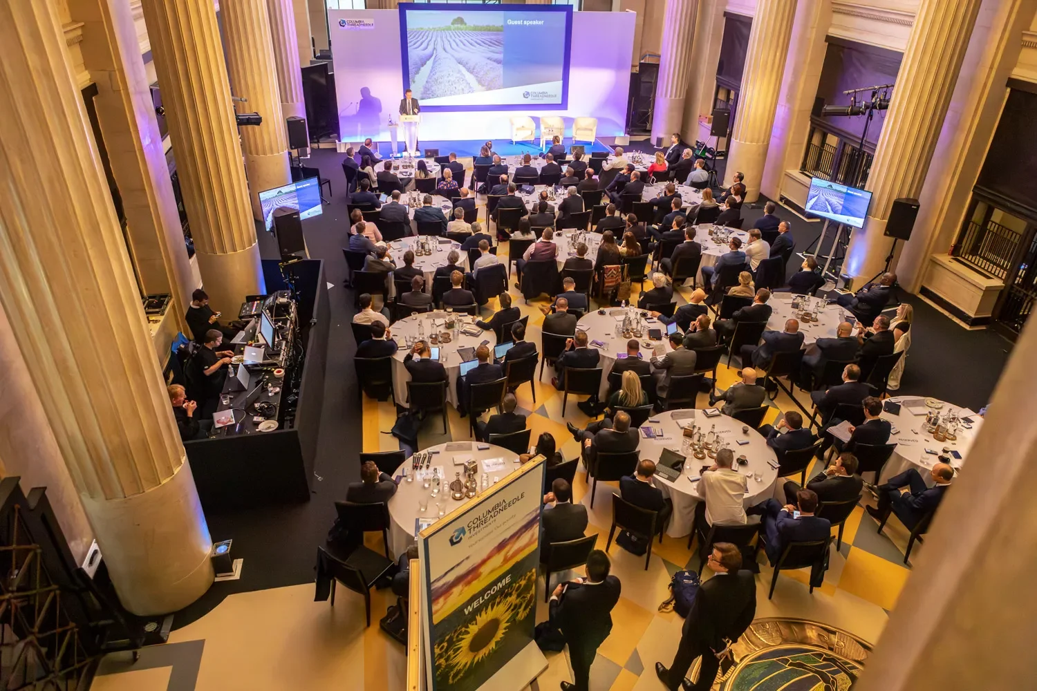 A large group of people are seated in a room, attending a London conference.