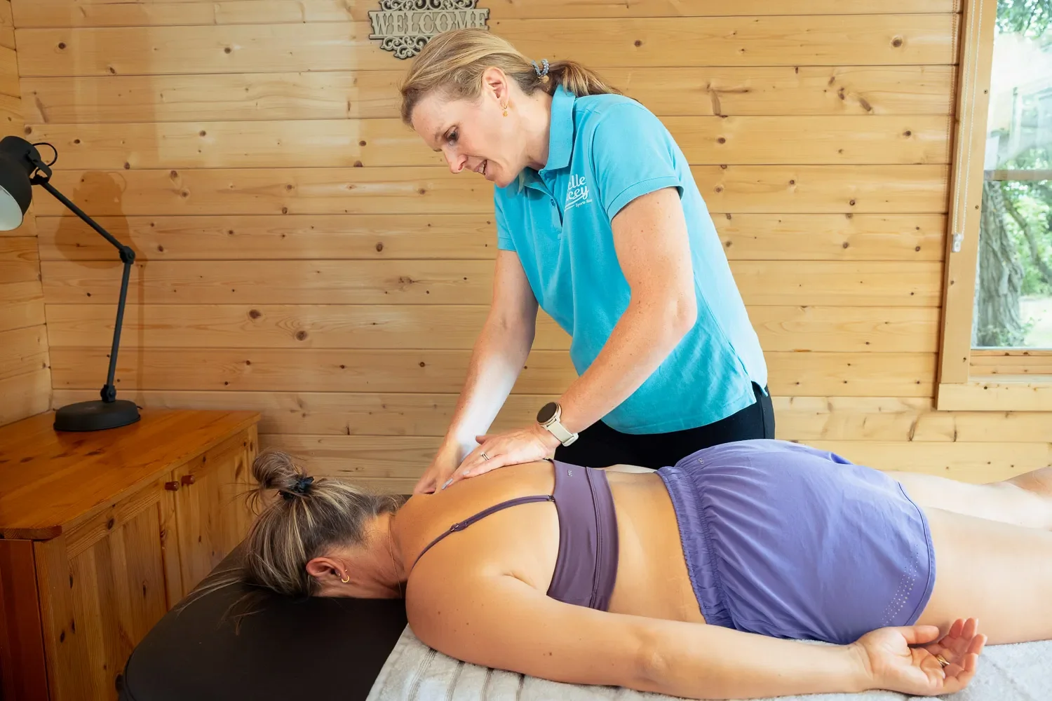 Sports massage therapist Michelle Stacey giving a back treatment in her Harpenden studio.