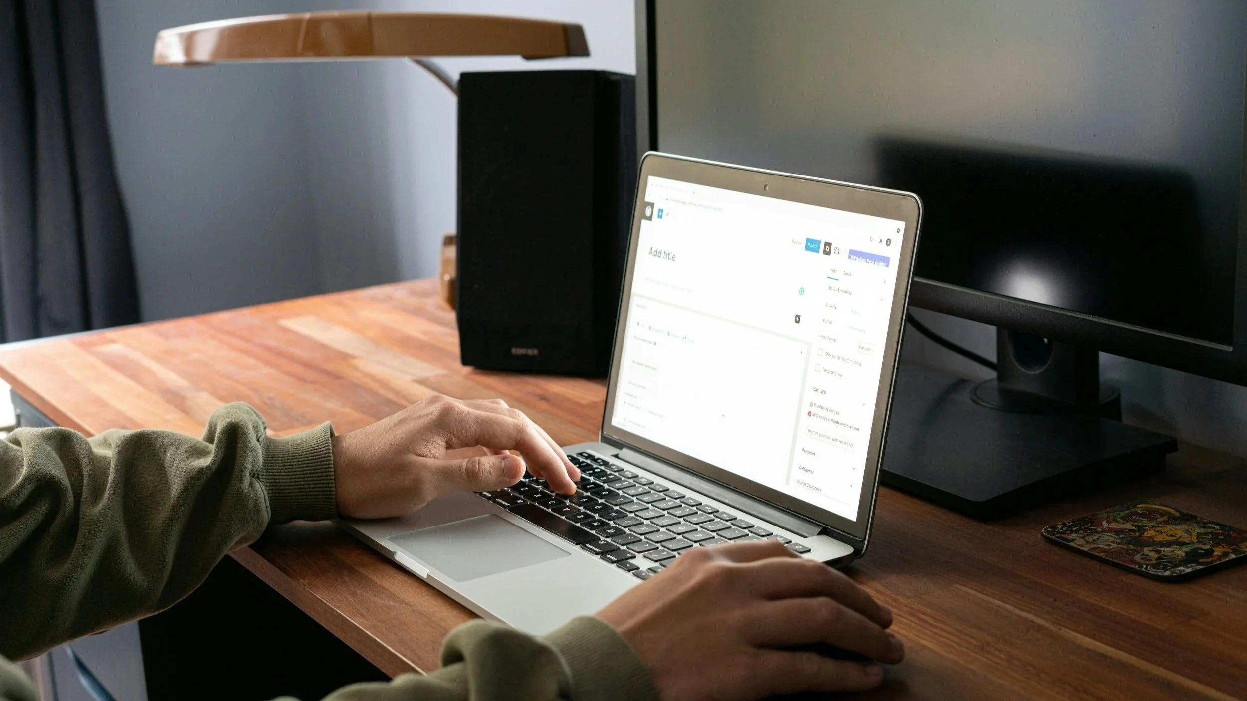 A web designer typing at a laptop, working on a website - Jarrett Beck Web Design, Tampa FL