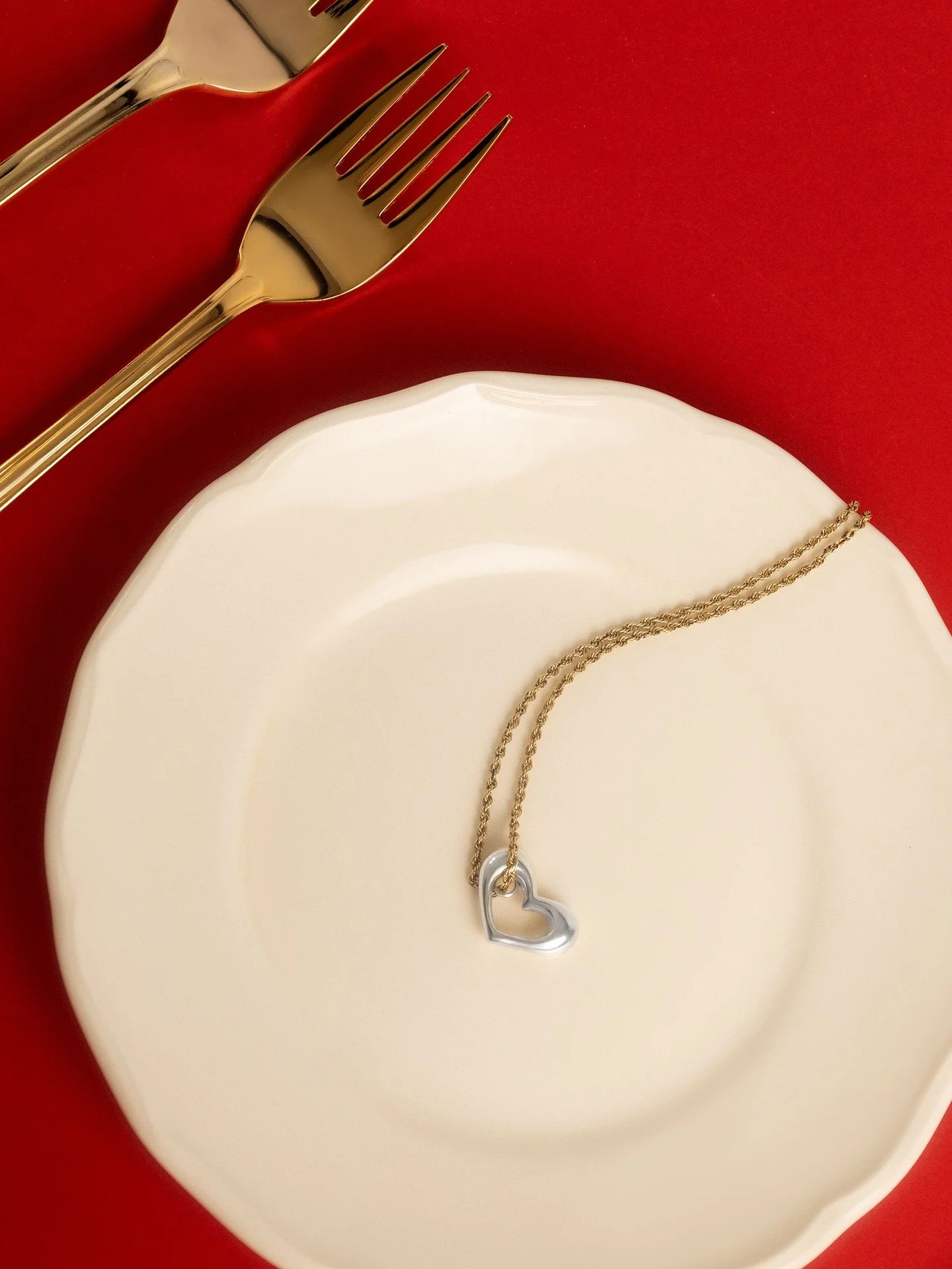 Sterling silver heart pendant, set against Maison Lipowa red.
A sculptural interpretation of a classic symbol &mdash; refined, weighted, intentional.

Handcrafted silver jewellery designed to feel modern, not sentimental.
.
.
.
#heartjewelry 
#contem