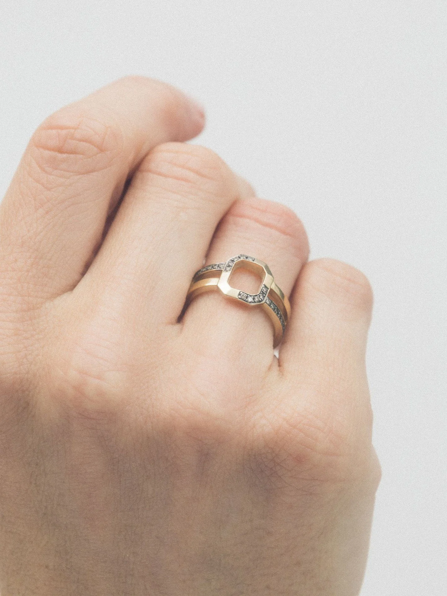 A modern geometric gold ring designed for everyday wear.
Clean lines. Open shape. Subtle diamonds for quiet contrast.

Crafted in solid gold and designed to stack or stand alone &mdash; a minimalist fine jewellery piece that feels architectural, not 