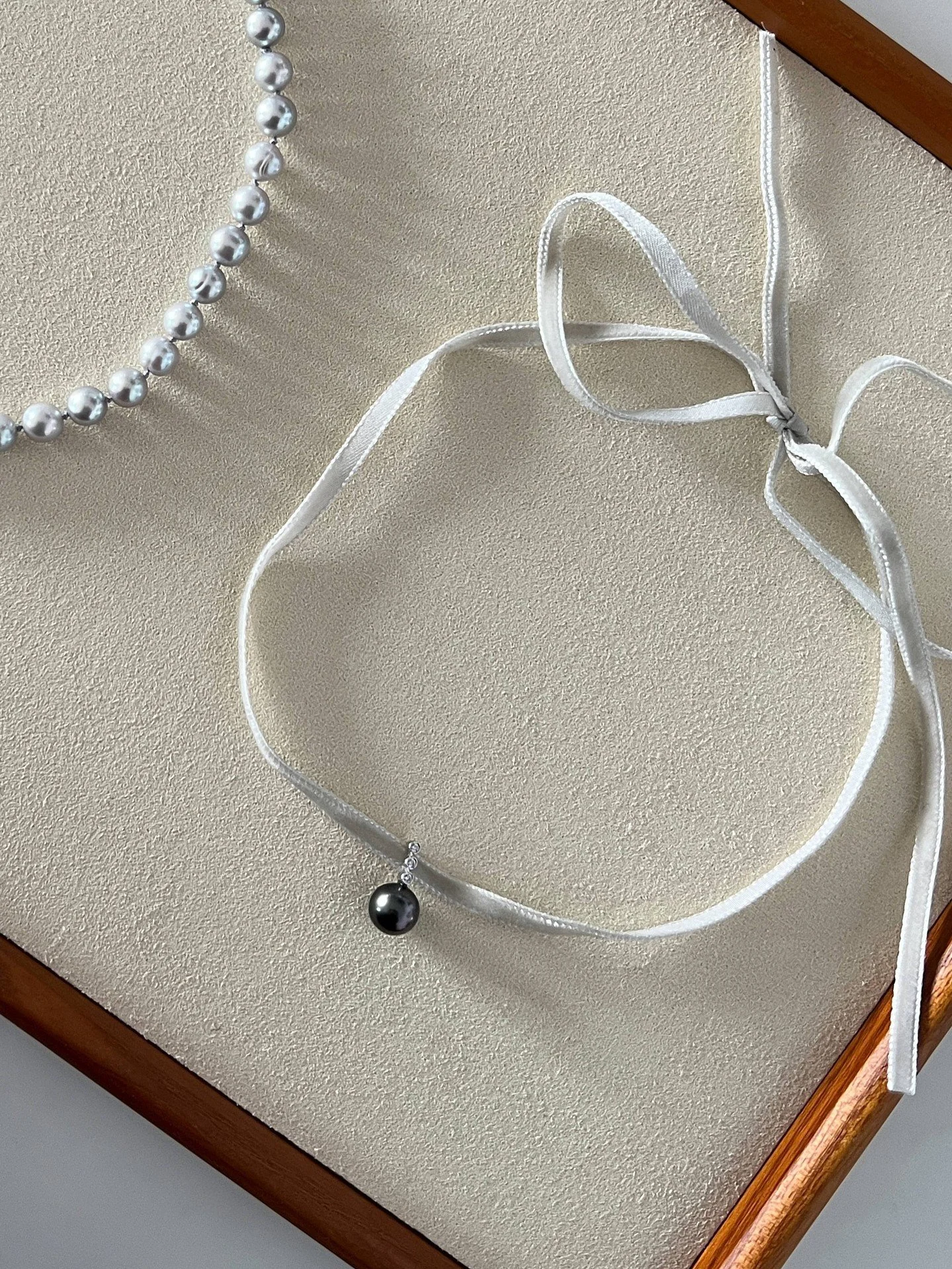 The dark luster of a Tahitian Pearl &mdash; not a shine, but a depth.

Light doesn&rsquo;t sit on its surface. It slips inward, softening into shadow, becoming something quieter, more deliberate.

A pearl, redefined &mdash; less innocence, more inten