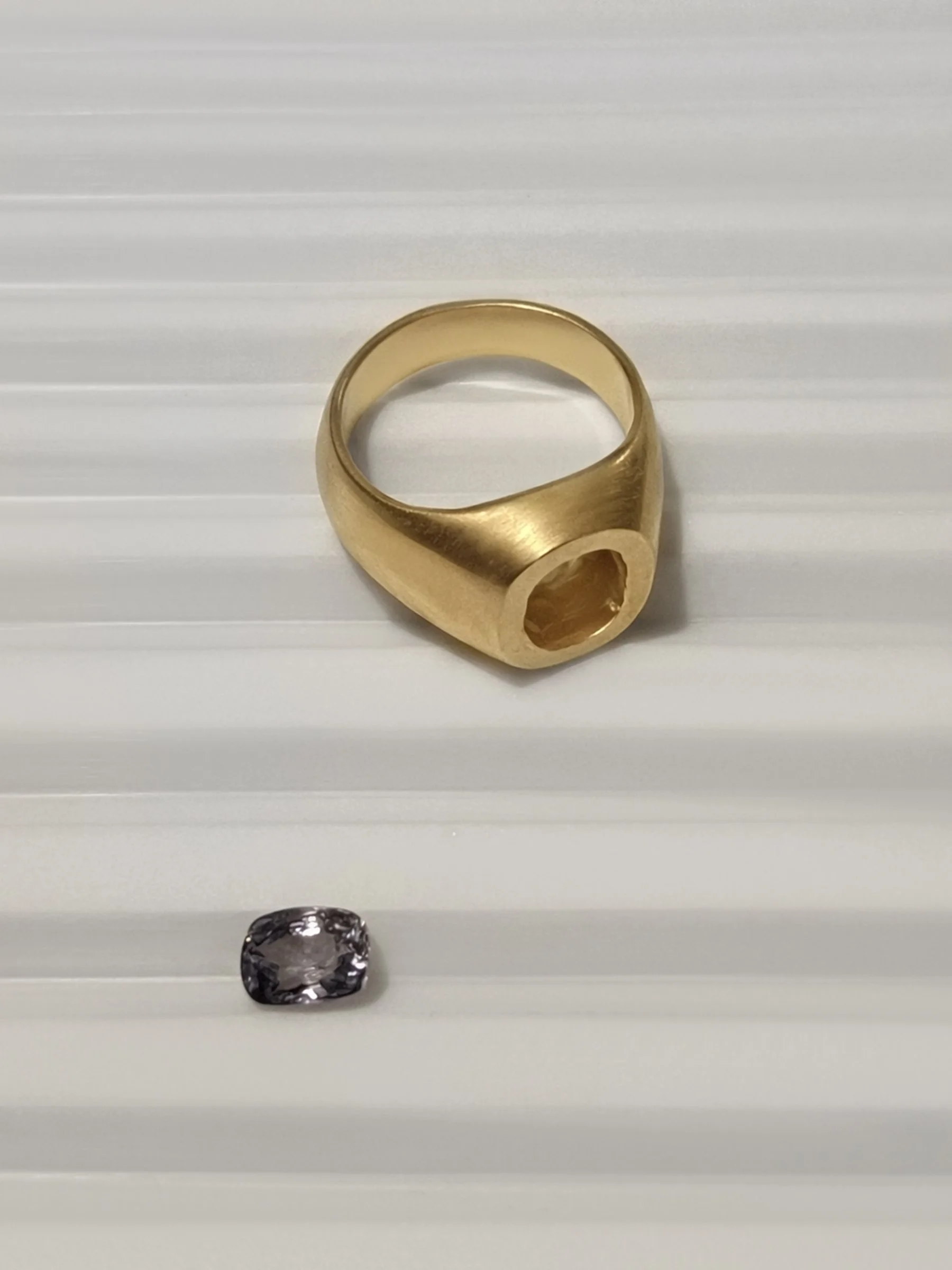 spinnel gem setting into gold pinky ring.jpg