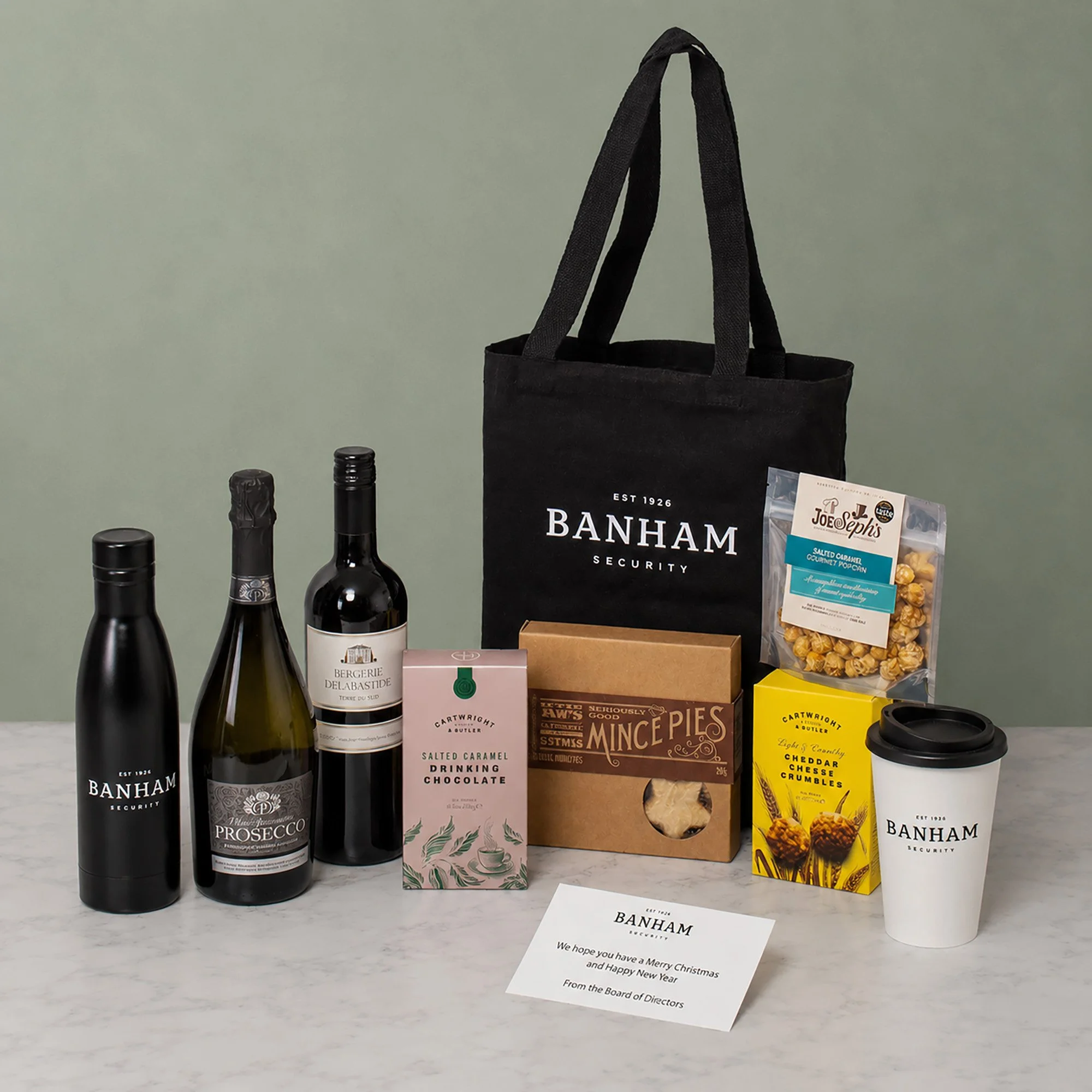 Bespoke Branded Festive Gift Bag with Prosecco, Wine, Sweet & Savoury Treats and Branded Water Bottle & Travel Cup, for Banham Security. 