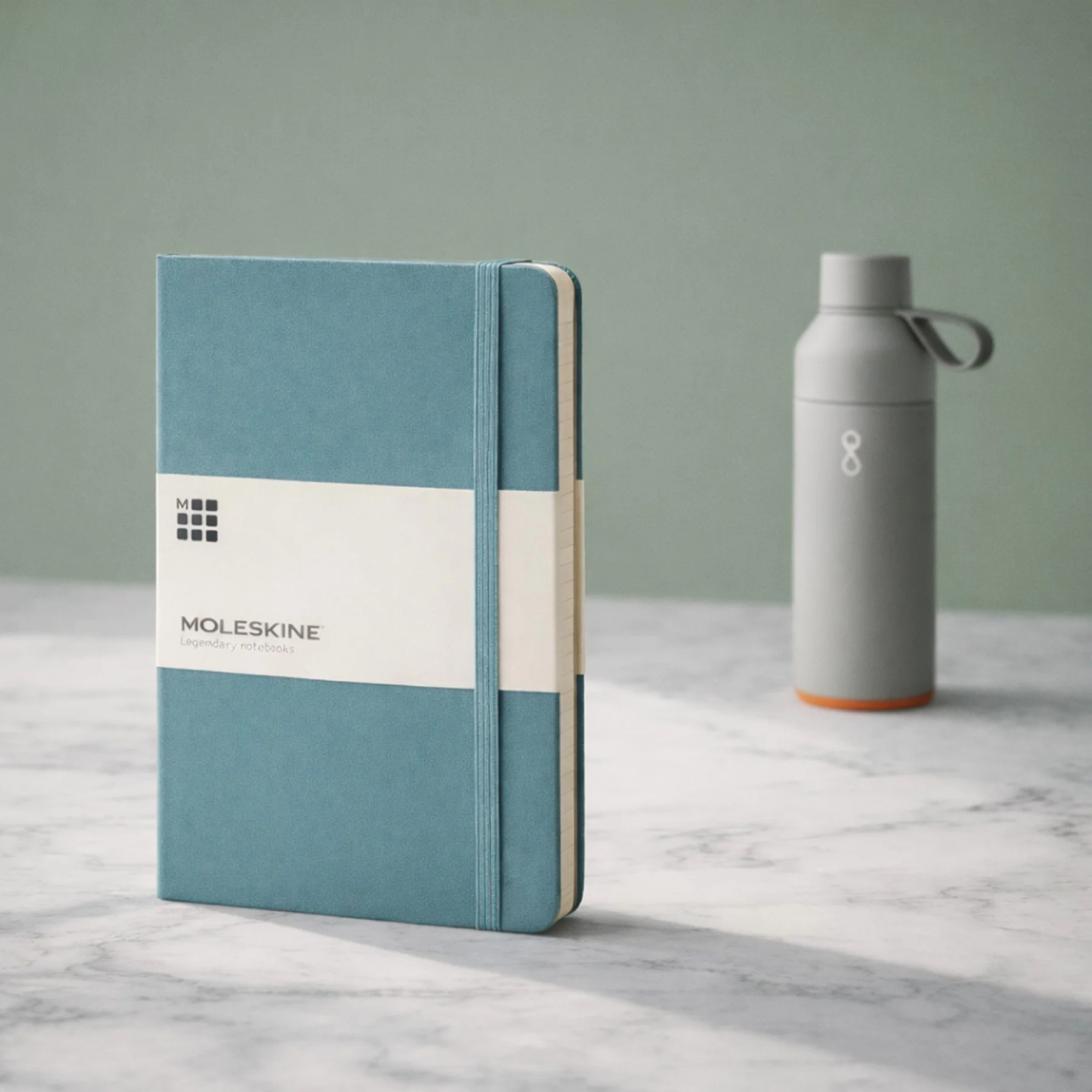 Example branded merchandise for corporate hampers including a notebook and bottle.