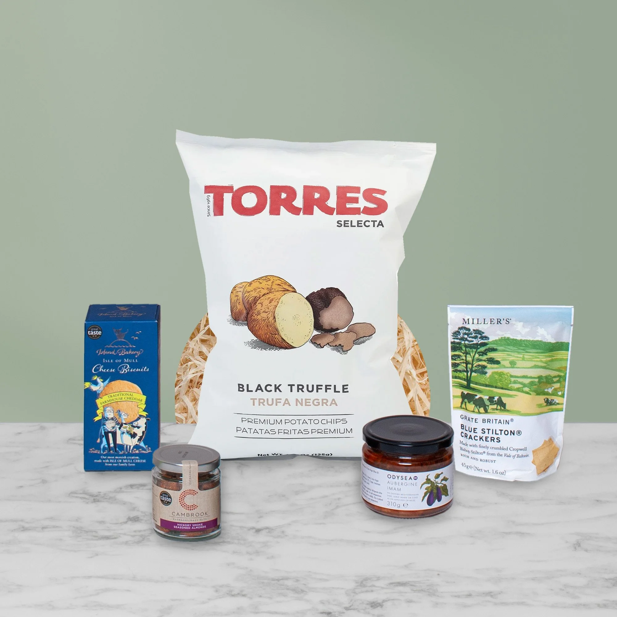 Savoury hamper snacks including luxury crisps, crackers, nuts and gourmet antipasti.